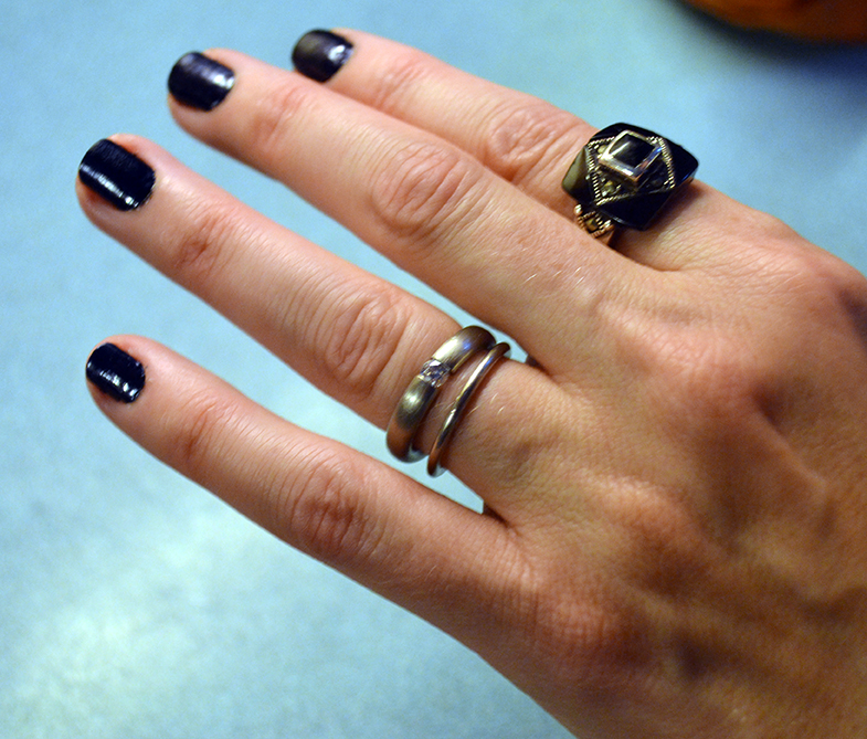 Tension setting round diamond engagement ring in grey gold with brushed matte finish paired with a gold wedding band