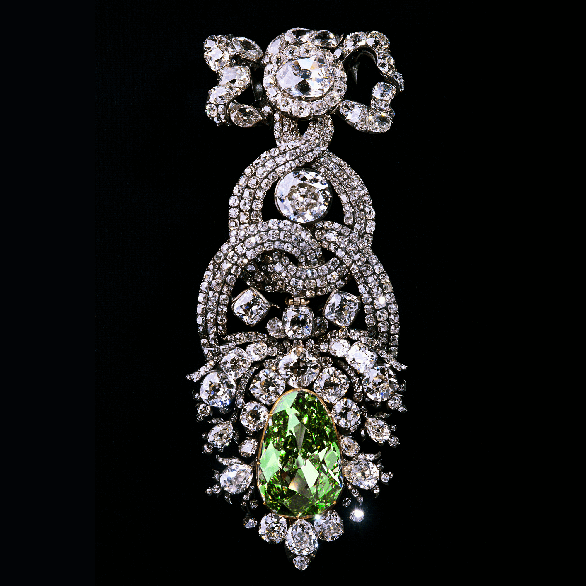 The Dresden Green Diamond: a modified pear-shaped pendeloque 40-carat green diamond decorated with several round cut diamonds set into a bejeweled hat ornament