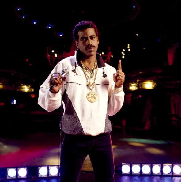 Sparkle and Sound: How Diamond Jewelry Has Endured in Music 1 Layered iced out chains & diamond chain pendants set in gold worn by 1980s hip hop artist Kurtis Blow