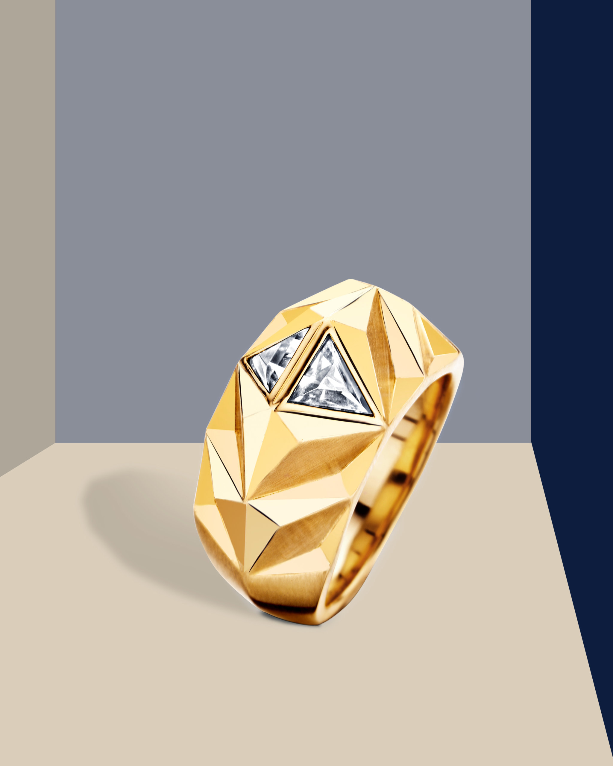 Faceted yellow gold gypsy ring with two triangle cut diamonds 