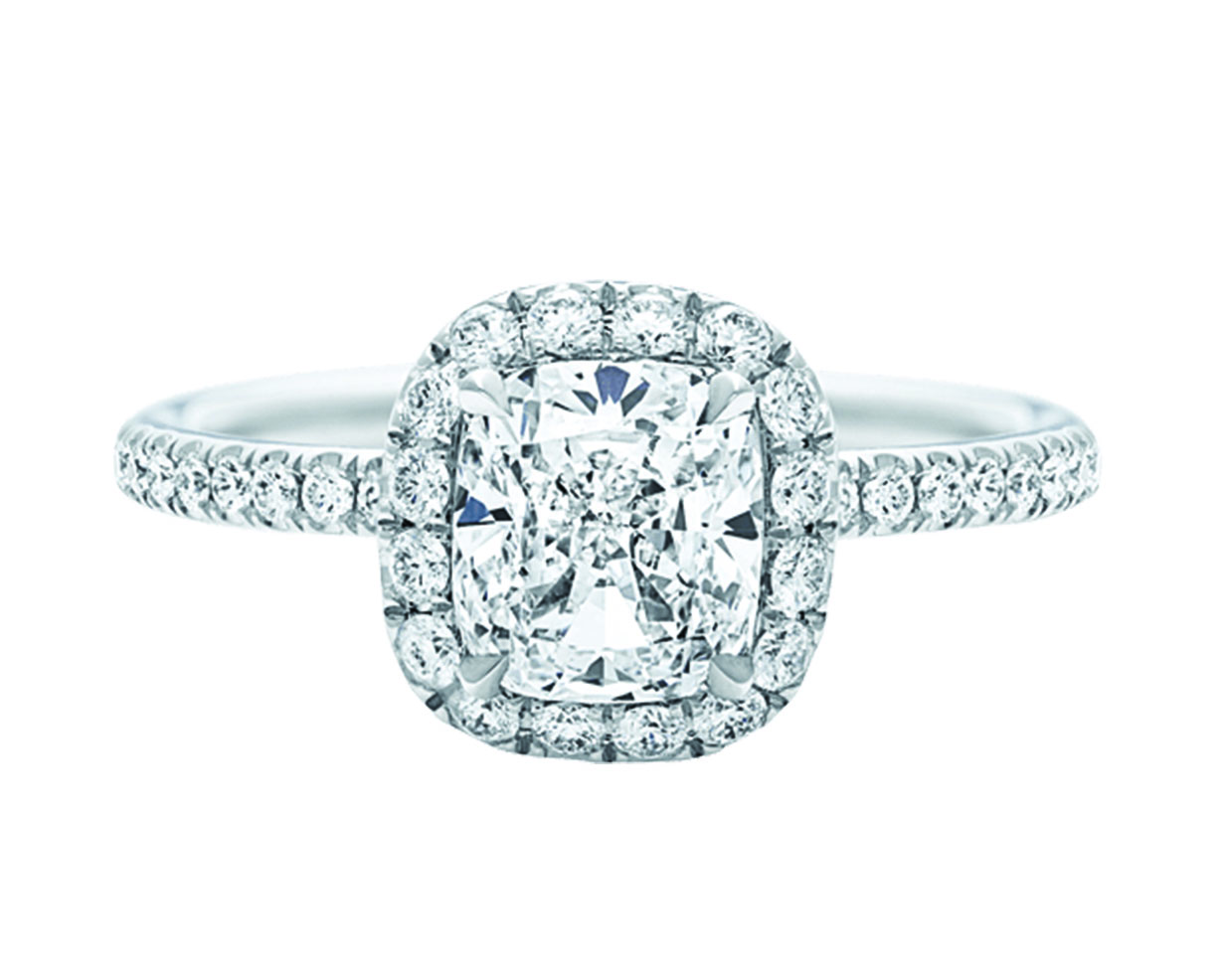 Cushion cut diamond center stone ring with paved halo and platinum pave band