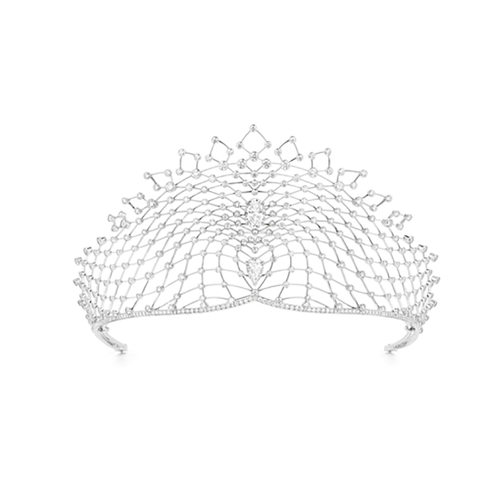 Diamond tiara with an oval cut & flipped tear drop diamond centered within white round cut diamonds by Chaumet