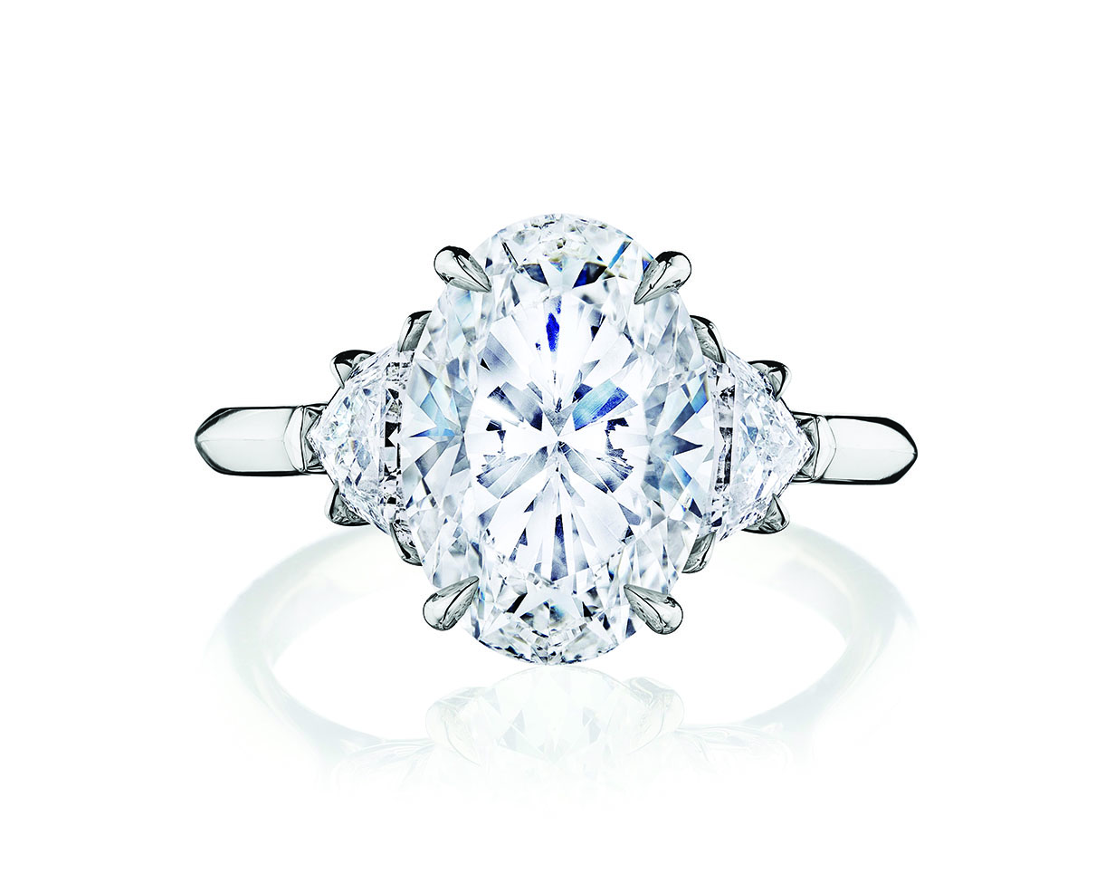 The 5 C's of Diamonds (Yes, 5): How to Select the Perfect Engagement Ring 6 Oval cut diamond center stone engagement ring with two side diamonds on a platinum band