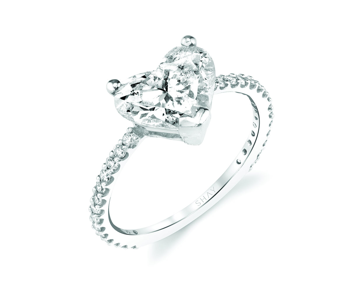Heart cut diamond center stone engagement ring with platinum pave band