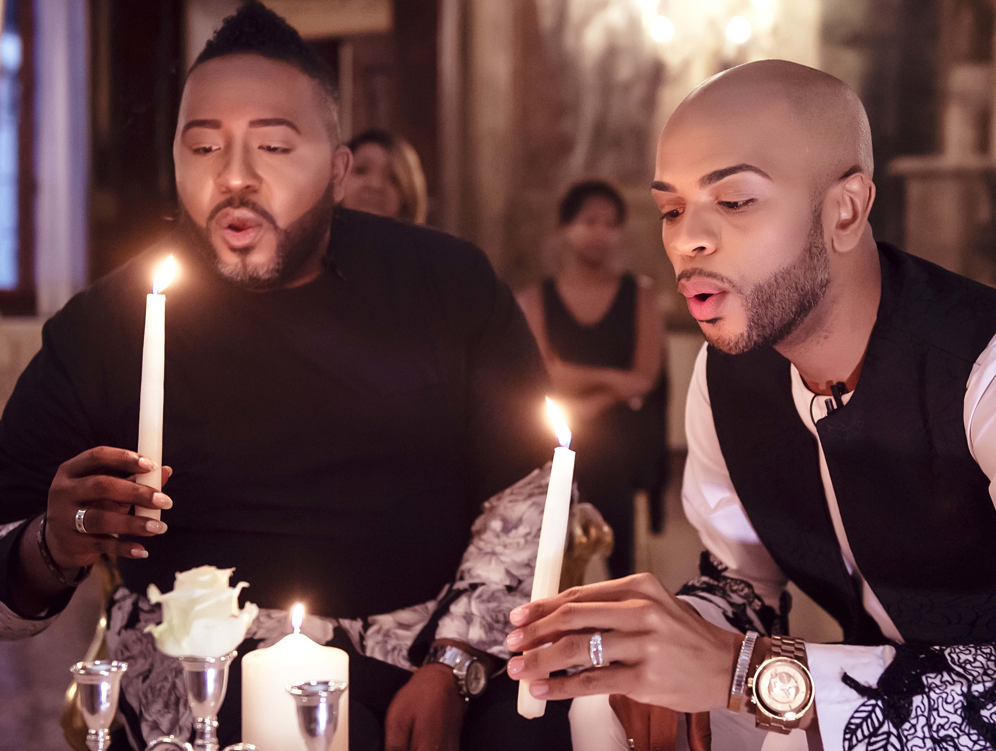 David and Johnny Lester-Massey blowing out ceremony candles wearing white gold baguette diamond ring bands by Atlanta West Jewelry.