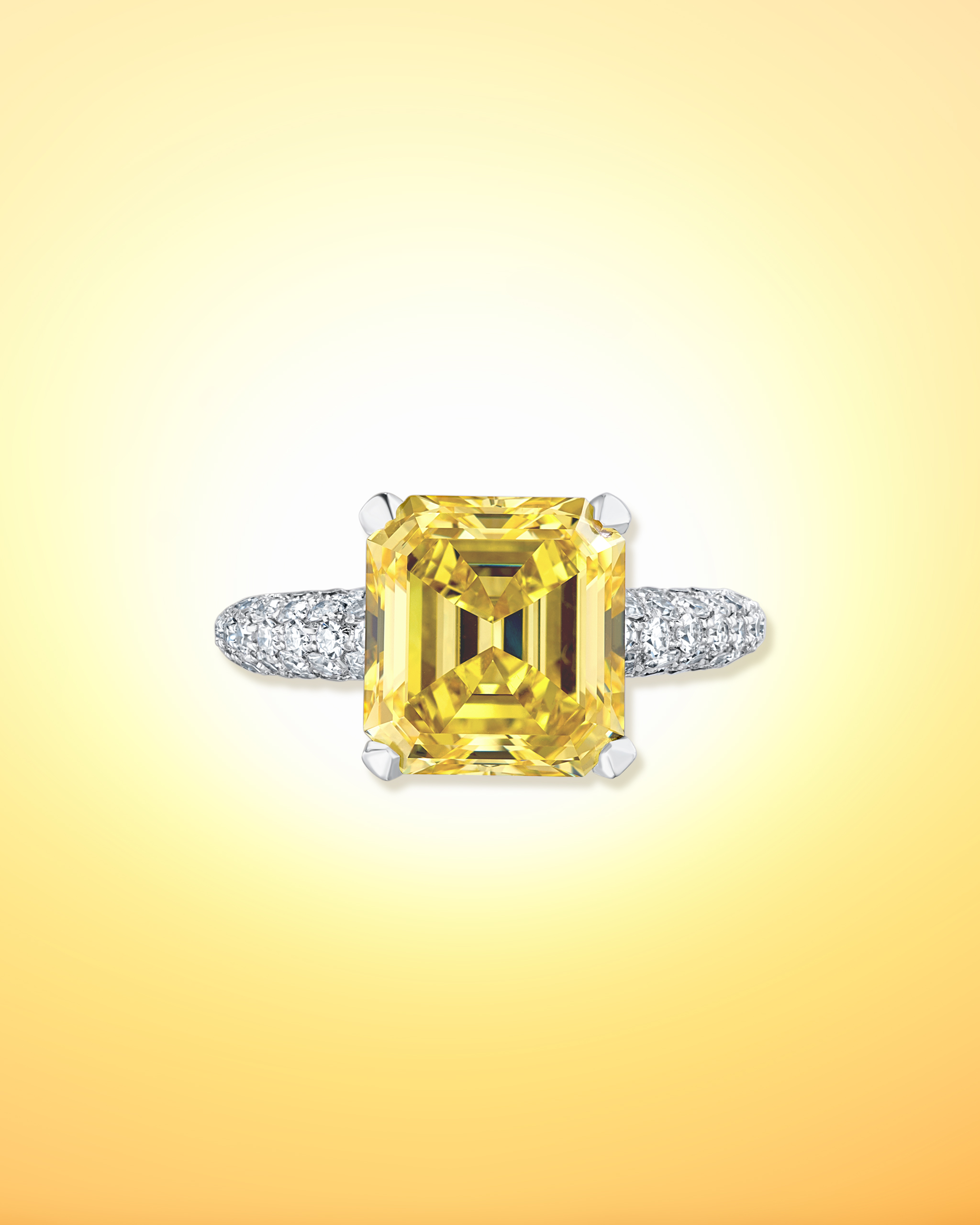 Squared, emerald cut yellow diamond ring on a white diamond encrusted band from David Morris