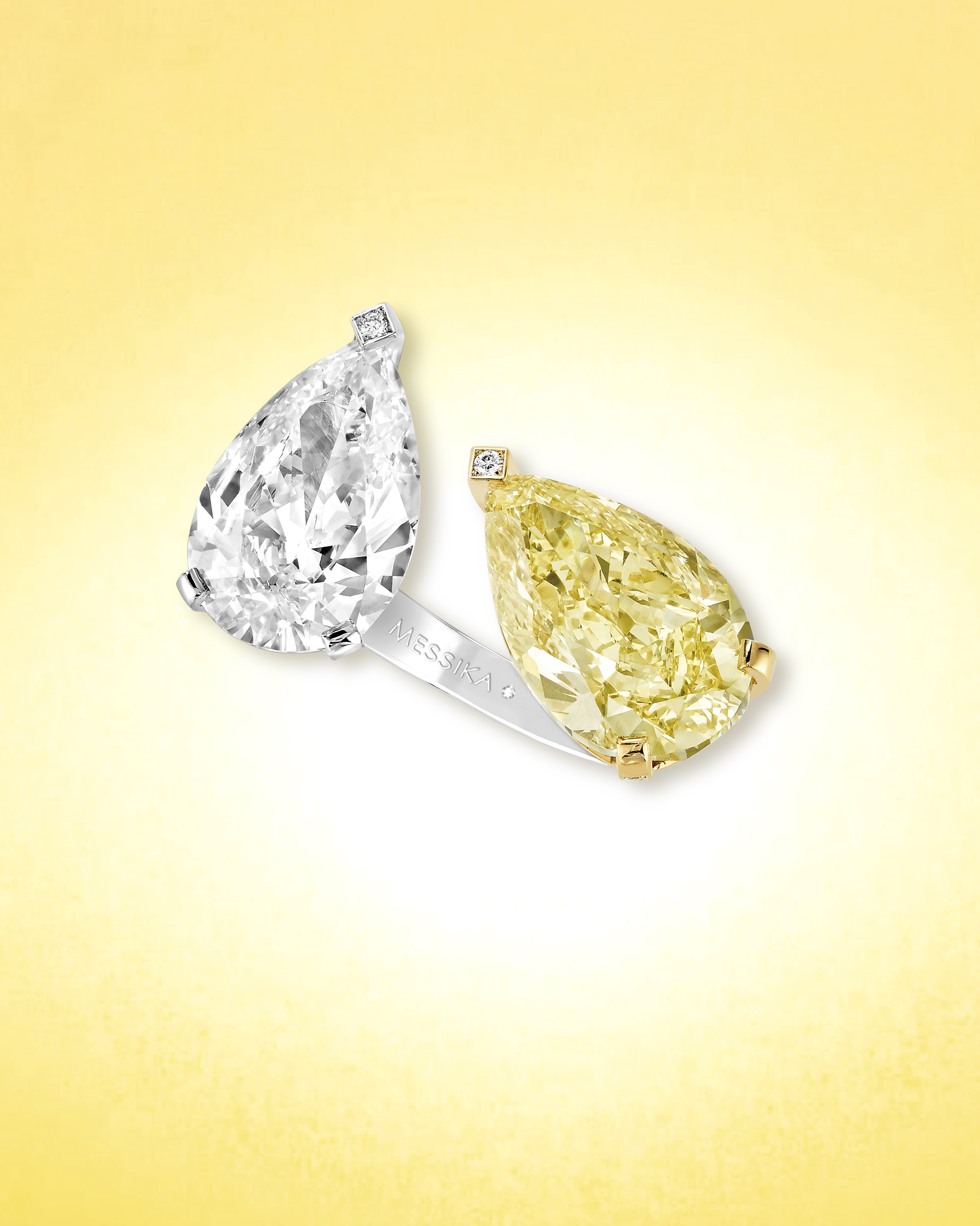 Yellow and white pear shaped diamond ring in a toi et moi setting on a platinum band from Messika