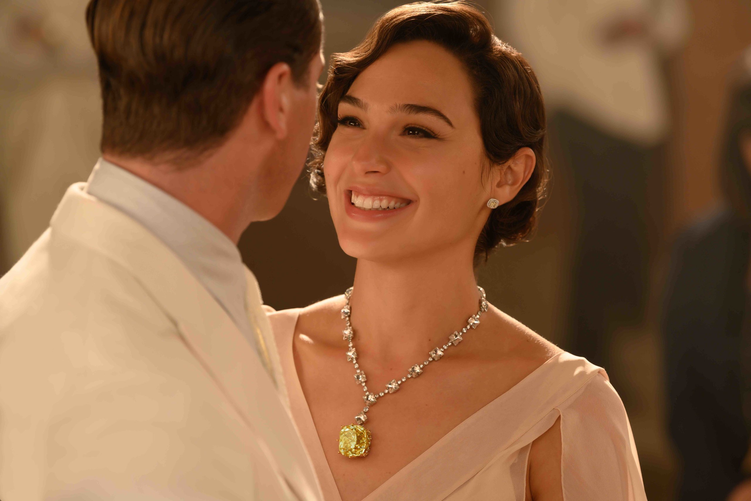 Gal Gadot wearing a diamond necklace with a 128-carat Tiffany yellow diamond and diamond studs in the Death on The Nile movie