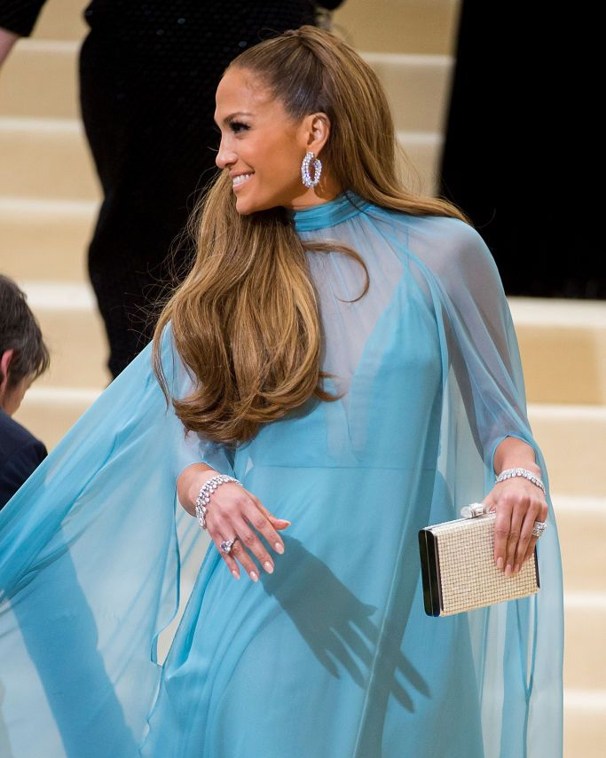Jennifer Lopez hoop earrings look at the 2017 Met Gala featuring Harry Winston diamond hoop earrings and a turquoise blue Valentino gown