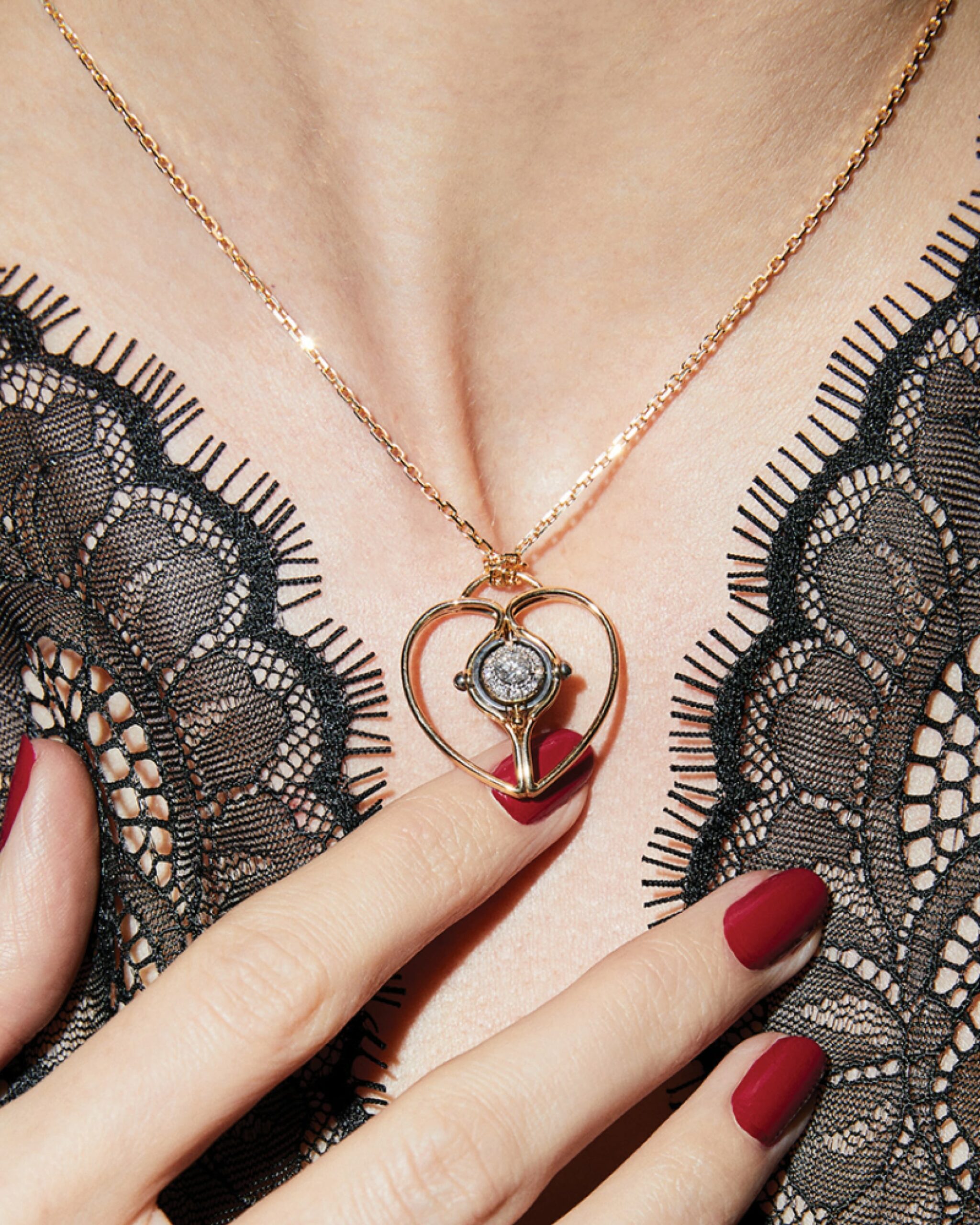 Mira Heart Charm necklace from Elie Top featuring a central diamond and gold heart necklace design