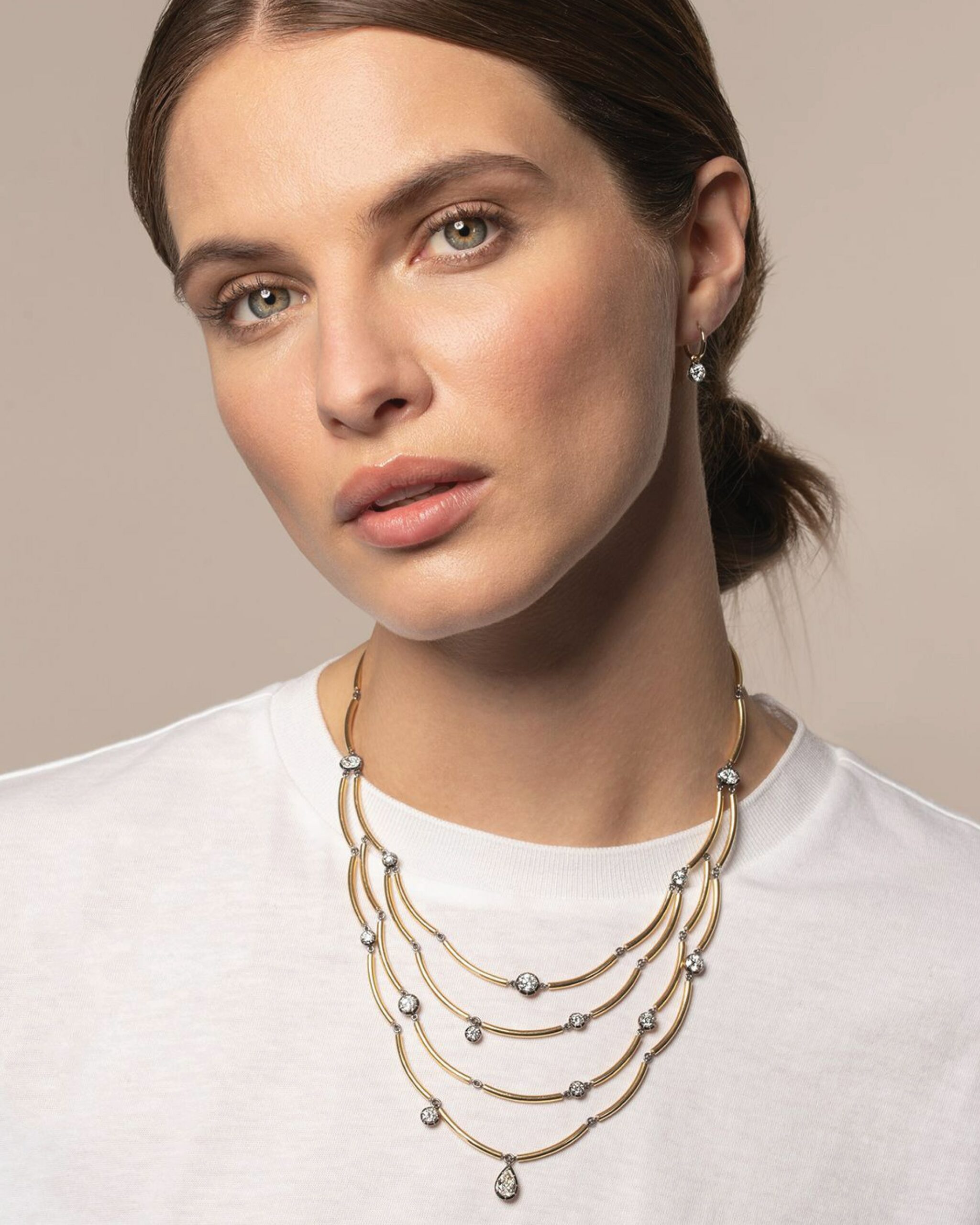 Chi Chi layered gold necklace from Jessica McCormack featuring several round cut diamonds across 4 strands