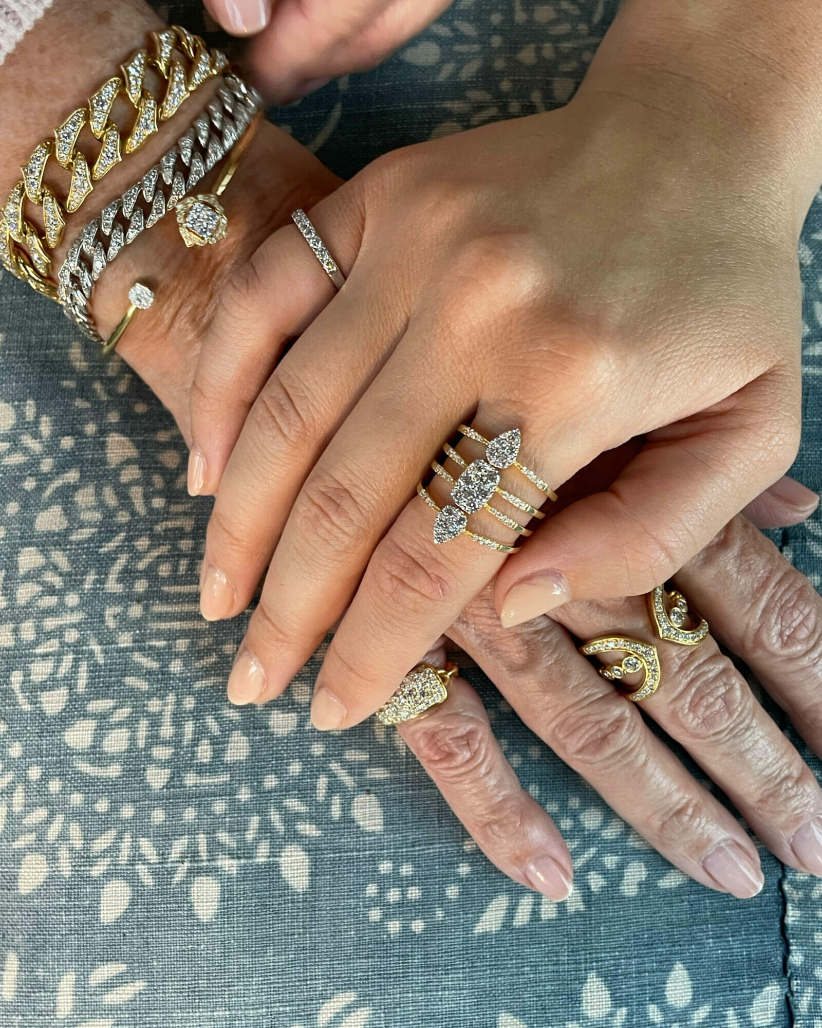 Sara Weinstock and daughter Katie hands full of diamonds jewelry. 
