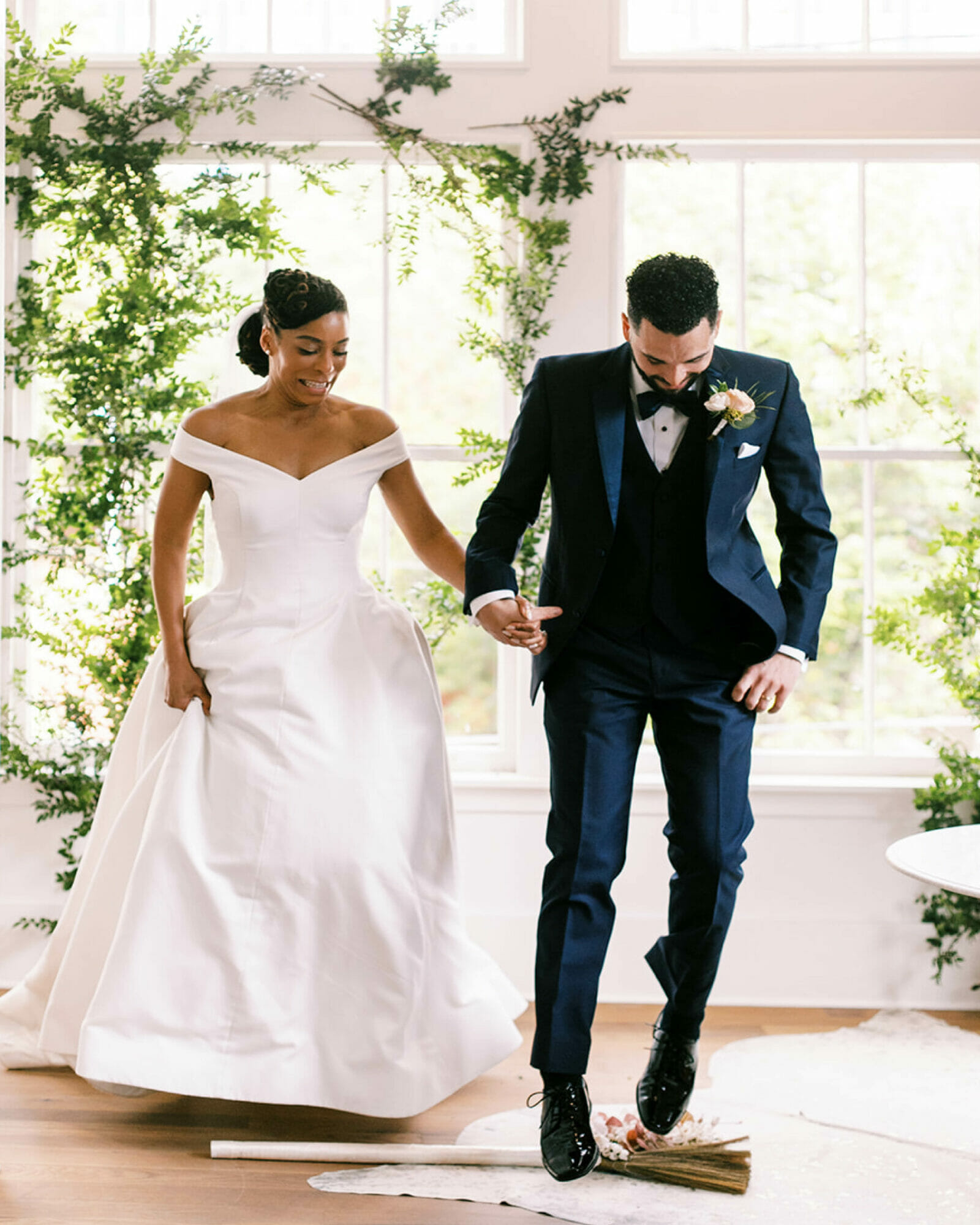 Commitment Across Cultures: This Couple Downsized Their Pandemic Wedding in Atlanta 9 Camille and Gio jump the broom.