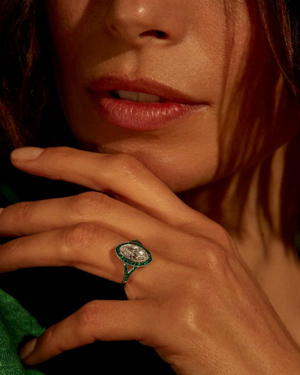 Marquise cut ring, woman wearing kwiat diamond ring, green closeup