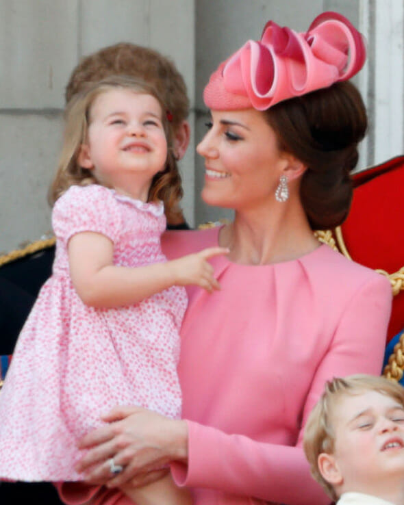 Kate Middleton wearing diamond jewelry with Princess Charlotte