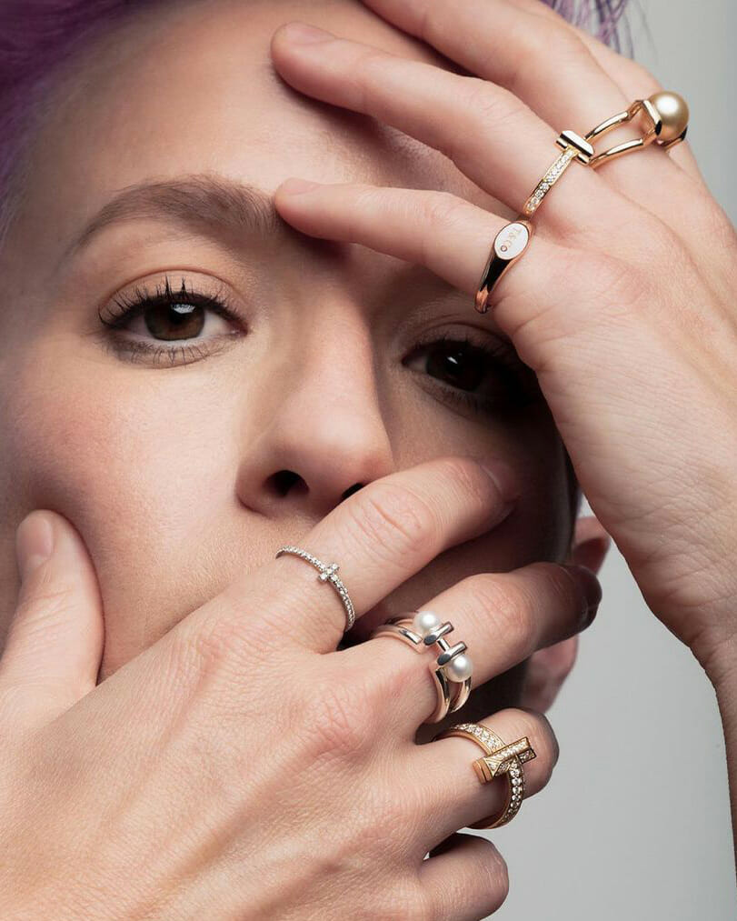 Soccer player Megan Rapinoe wearing, gold, diamond and pearl Tiffany & Co. rings. 