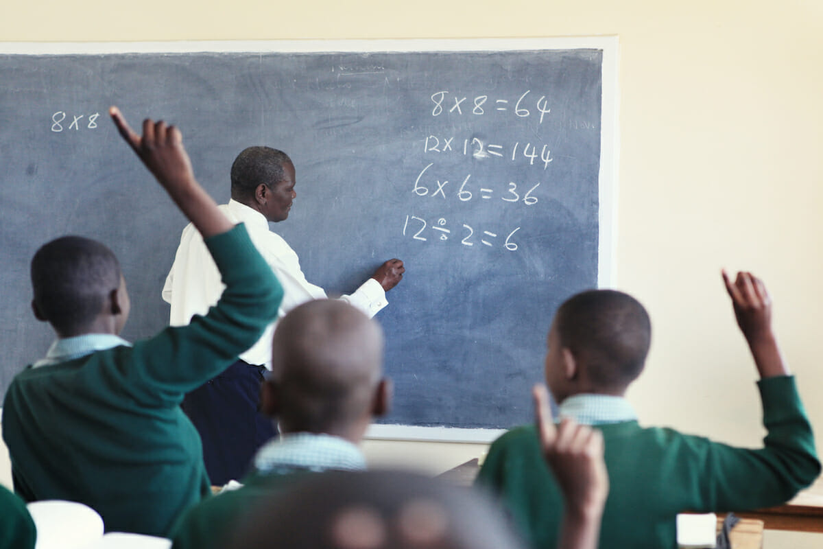 Teacher writing on the board.