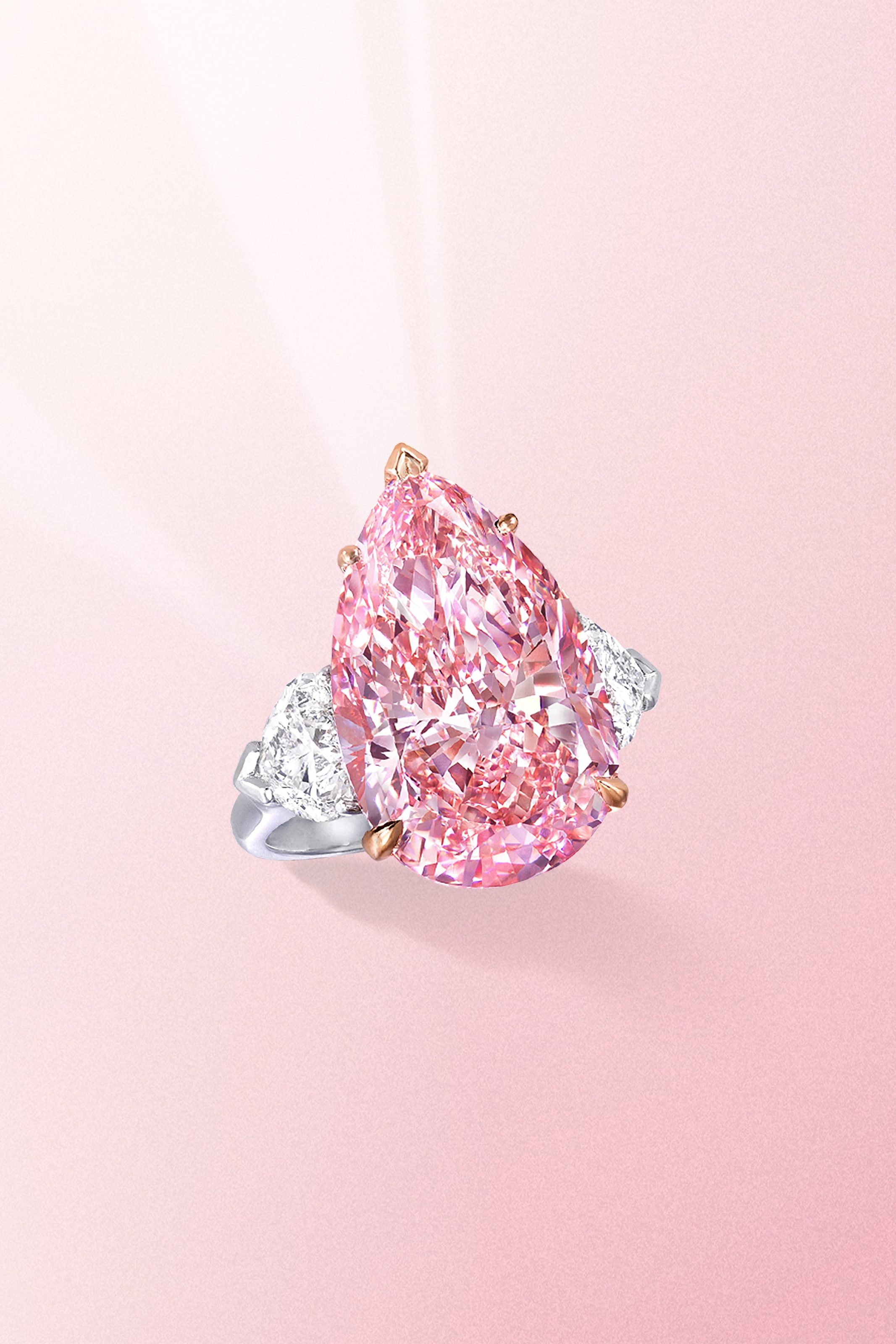 Pink Diamonds are a Miracle of Nature 3 Fancy vivid pear shaped pink diamond ring with side white diamonds on a platinum band from Graff