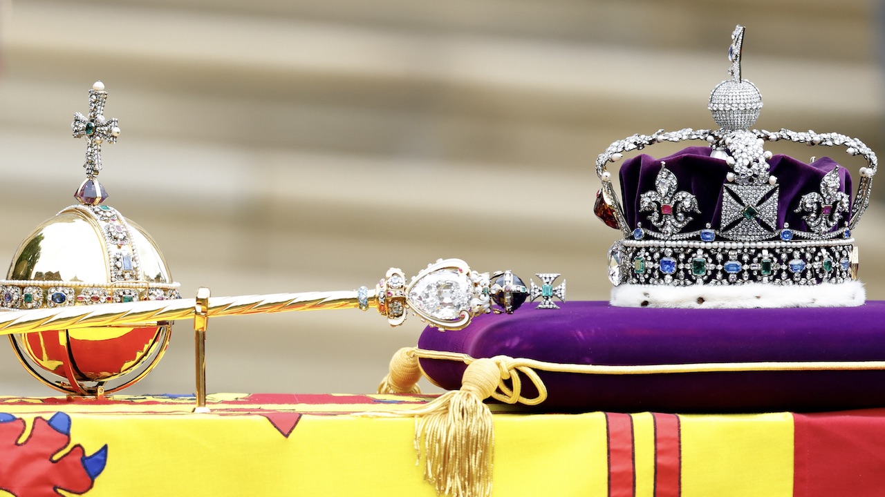 The Sovereign's Orb, Sceptre and The Imperial State Crown sit on top of Queen Elizabeth II's Royal Standard draped coffin at her Committal Service at St George's Chapel, Windsor Castle