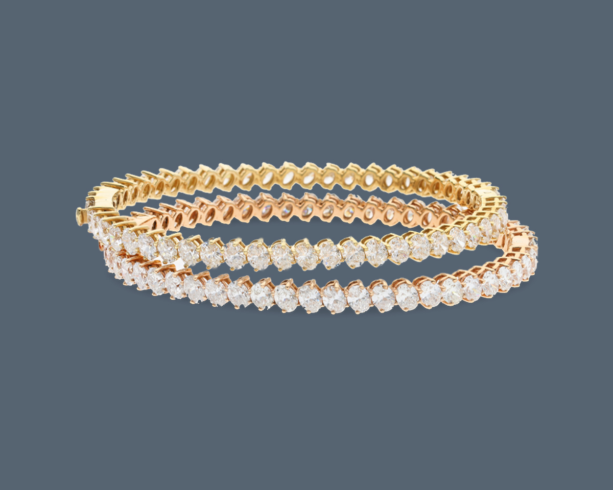 A pair of gold bangles embedded with diamonds