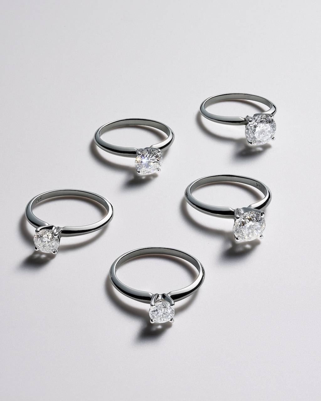 Five diamond rings showing less carat weight