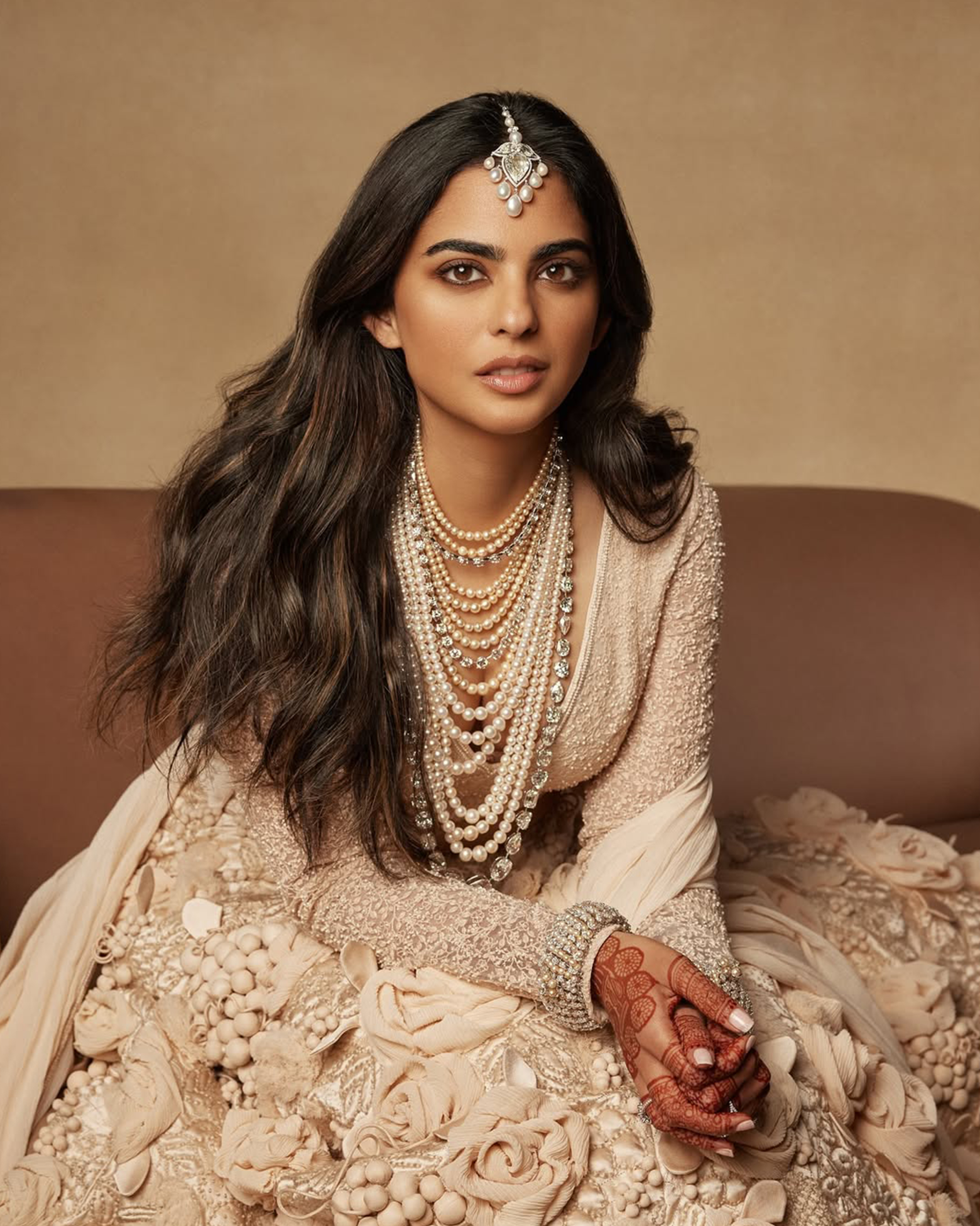 Isha Ambani’s layered pearls and diamonds necklace with maang tikka, kada, and diamond rings at Anant Ambani’s wedding reception