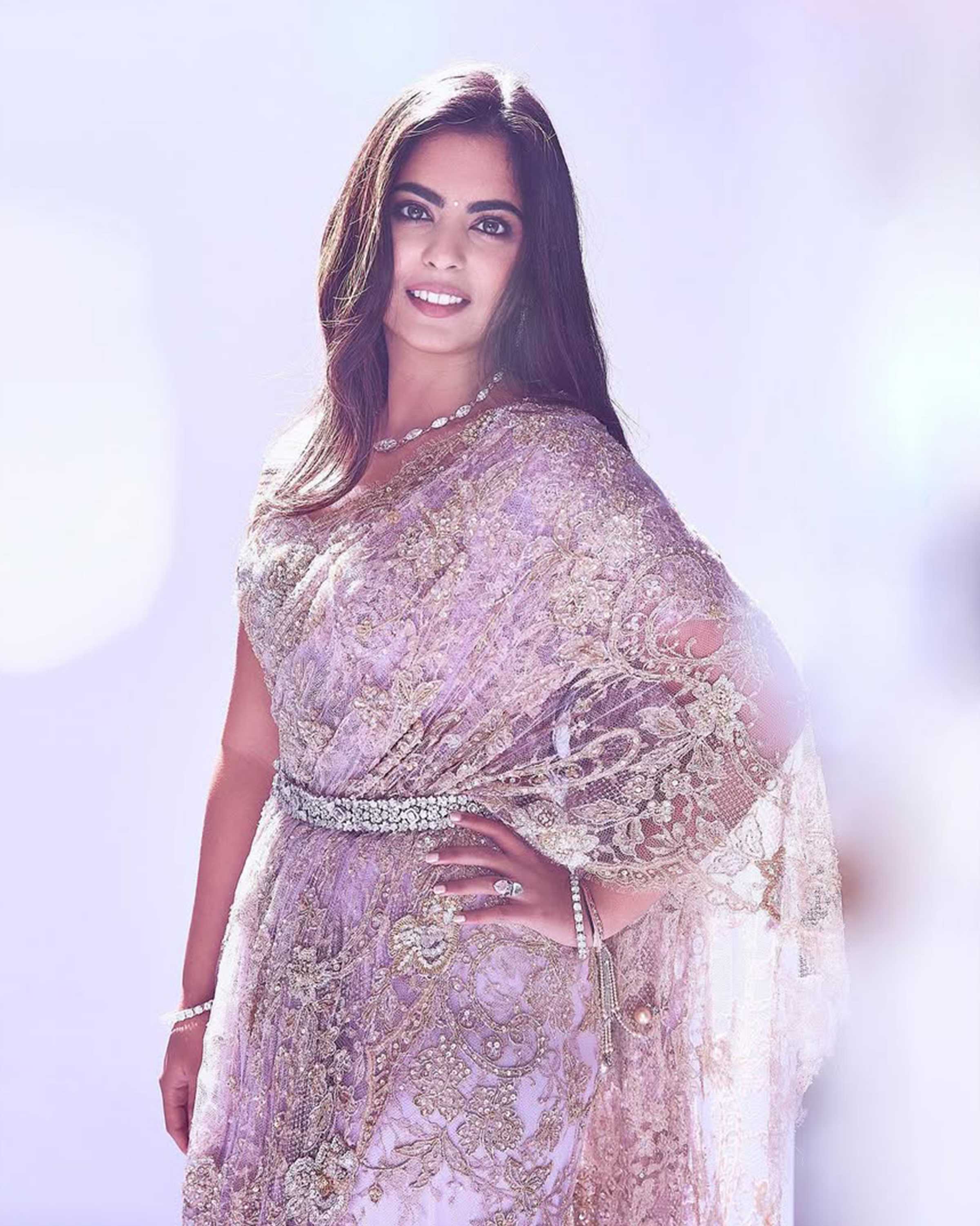 Diamond belt cinched the waist of the lilac lace saree at Isha's cousin's pre-wedding bash