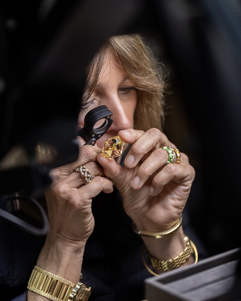 Victoria Wirth Reynolds examines the 128.54-carat yellow Tiffany Diamond. (Courtesy of Tiffany & Co.)