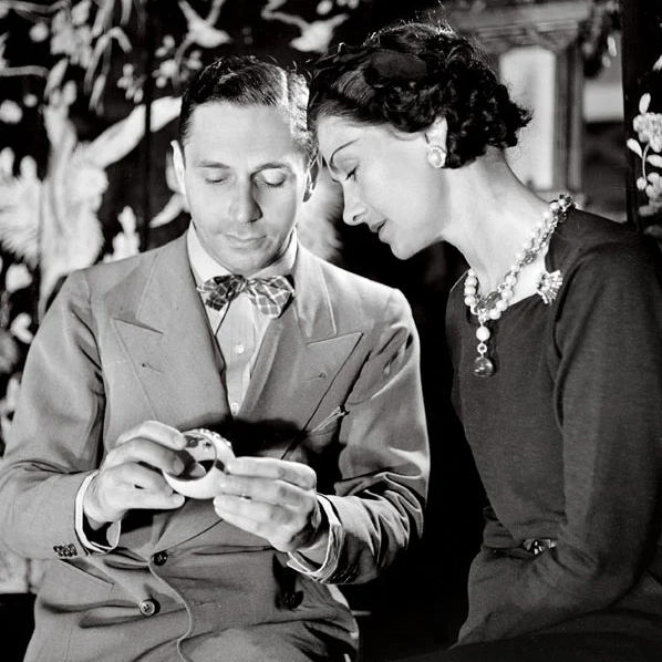 Duke Fulco di Verdura and Coco Chanel examine a jewelry design in her Paris apartment