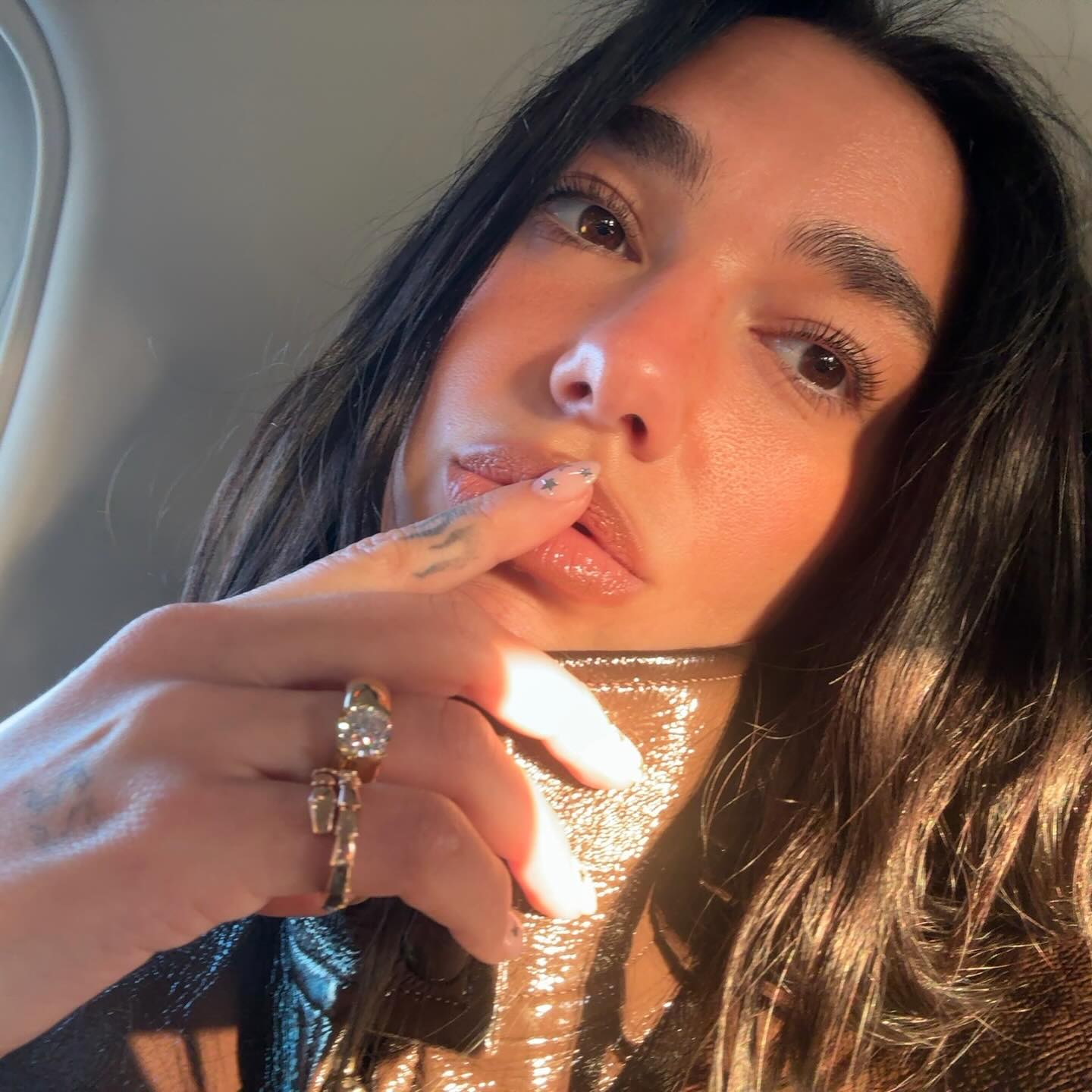 Dua Lipa shows off her diamond engagement ring gold and diamond bombe ring
