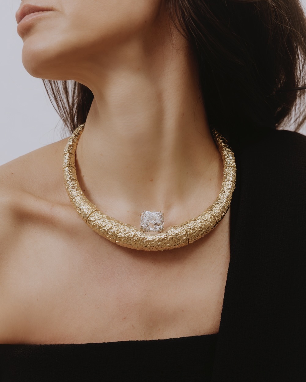 30.05-carat white diamond in a white diamond setting and 18K Fairmined gold raw necklace. The Row dress.