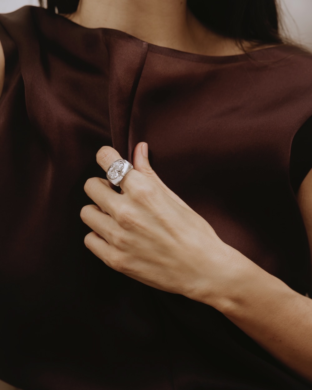 Ana Khouri ring with a 5.18-carat white diamond, rock crystal, and 18K Fairmined gold. Khaite dress.