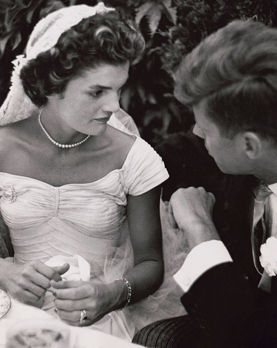 Jacqueline Bouvier Kennedy and John Kennedy talking at their wedding reception, Newport, Rhode Island