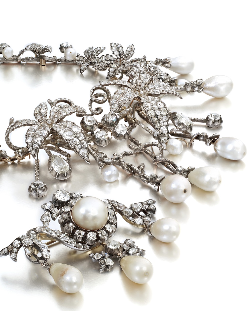 A Rare and Historically Important Natural Pearl and Diamond Hair Ornament and a Brooch