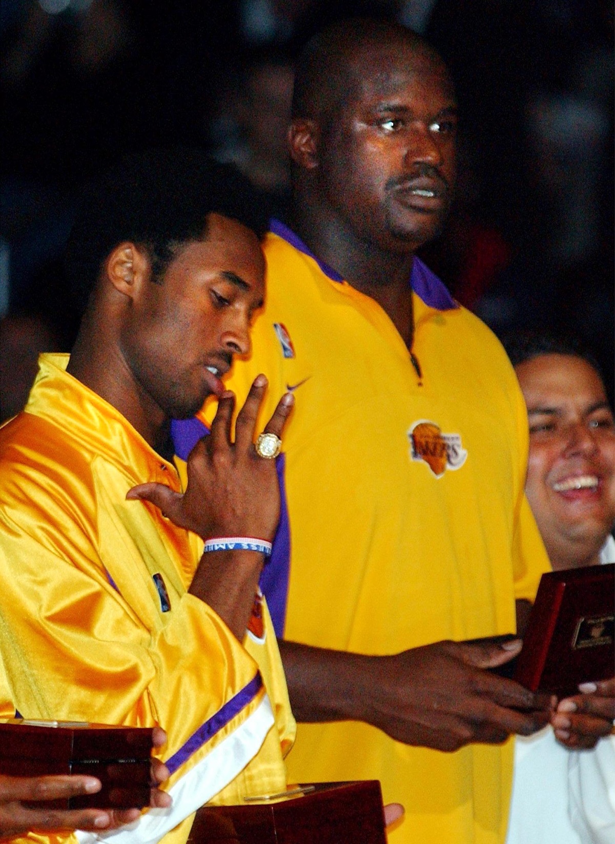 Kobe Bryant tries on his ring that he received for the 2000-2001 season during a ceremony before their game with the Portland Trail Blazers