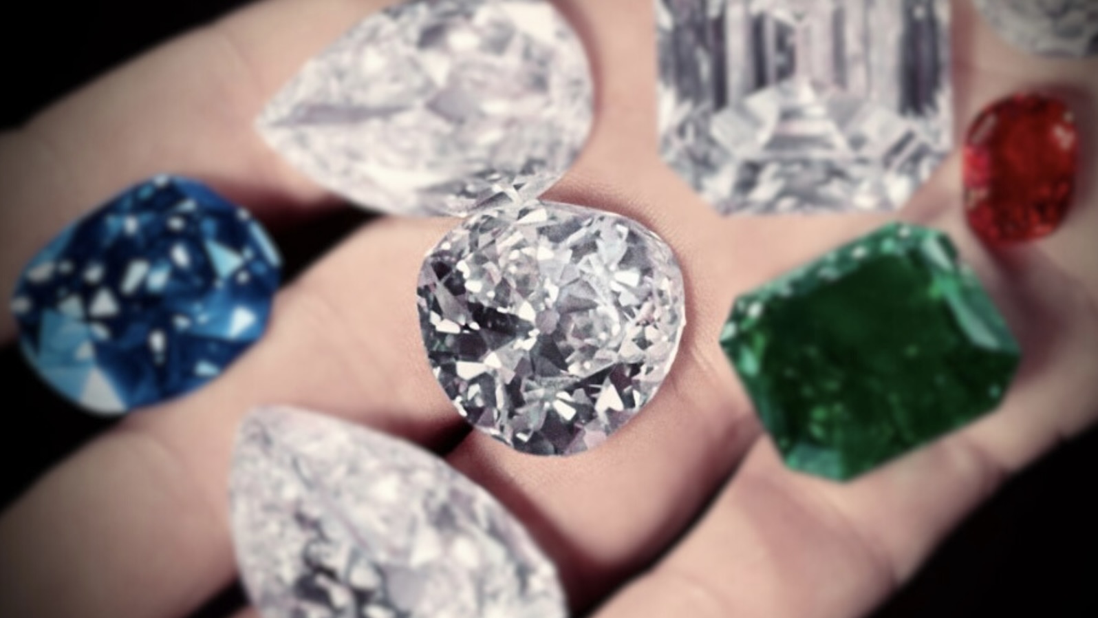 Harry Winston displays some of the gems in his collection in the palm of his hand, including the Sapphire of Catherine the Great (next to thumb), the Hope Diamond (between index & middle), the Royal Spanish Emerald (green), the Idol's Eye diamond (left of emerald), the Jonker Diamond (C, square cut), the Star of the East diamond (tear shaped, bottom), a large ruby and a pair of 50-carat matched pear shaped diamonds. (Photo by Bernard Hoffman/The LIFE Picture Collection/Getty Images)