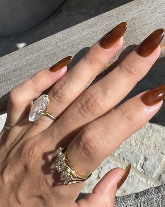 Hailey Bieber shows off her diamond "MOM" ring by Isa Grutman. 