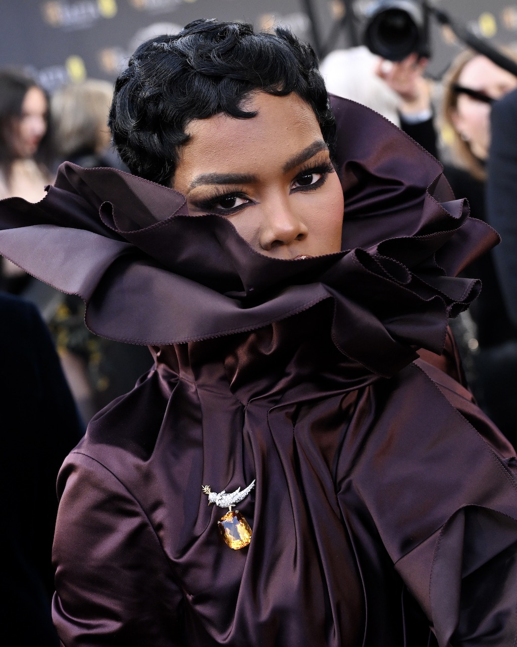 Teyana Taylor attends the BAFTA Awards 2026 in Tiffany Bird on a Rock brooch
