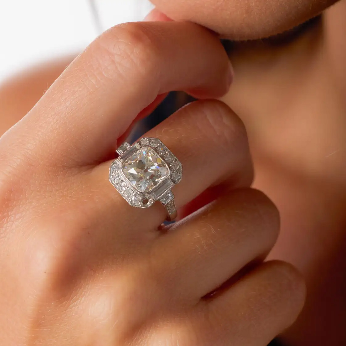 Old Mine Cut Diamond Platinum engagement ring, surrounded by twenty-two accent diamonds composed of single cut diamonds and baguette cuts, $55,000, 1stdibs.com