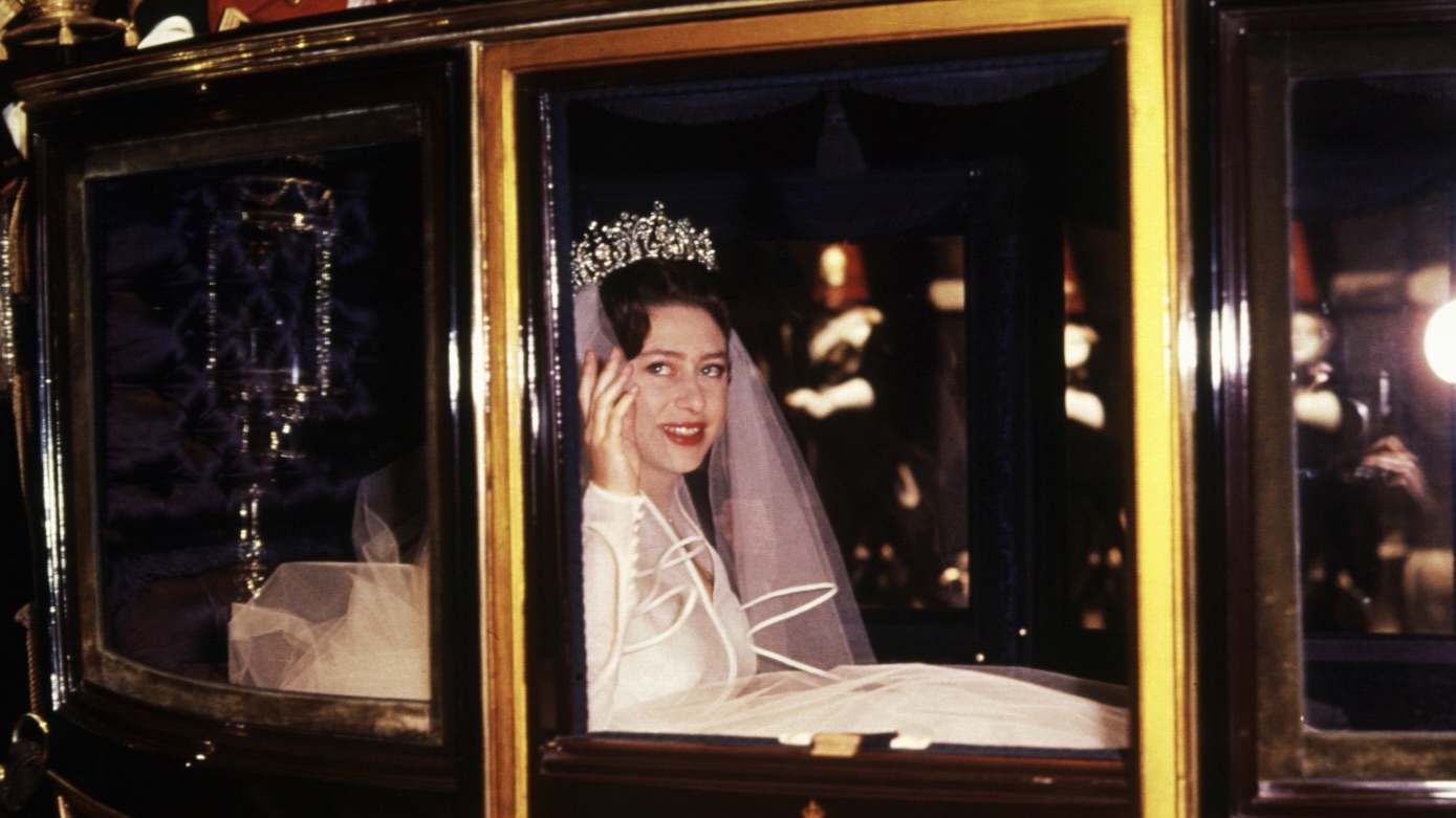 Princess Margaret waves from the Royal Coach during her wedding to Lord Snowdon in London. (Photo by © Hulton-Deutsch Collection/Getty Images)