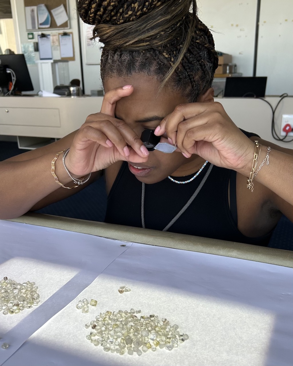 The author takes a closer look at the rough desert diamonds found in Namibia at TaTe Diamonds. (Courtesy of Leah Faye Cooper)