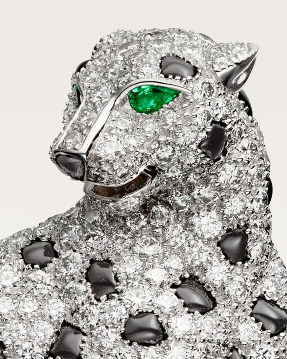 A Panthère de Cartier brooch features pavé diamonds and emerald eyes. (Courtesy of Cartier)