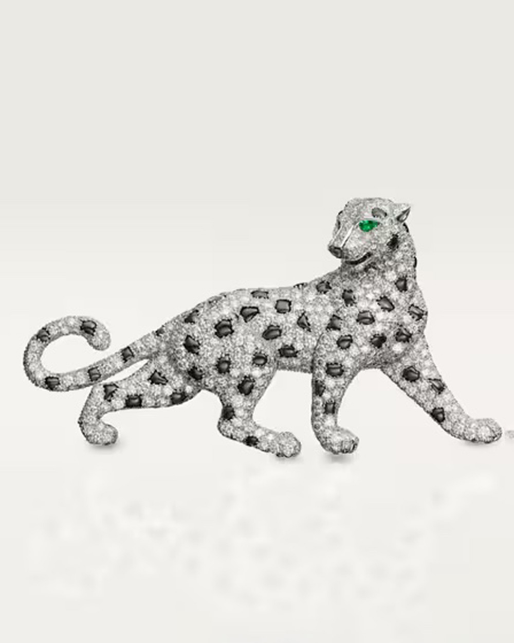 A Panthère de Cartier brooch features pavé diamonds and emerald eyes. (Courtesy of Cartier)