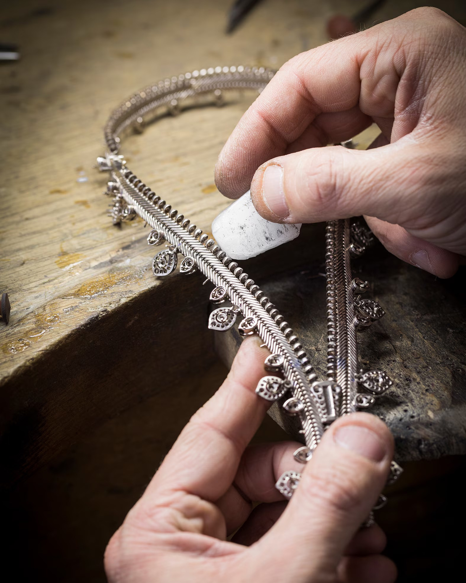 A Van Cleef & Arpels artisan polishes the intricate mechanism of the Maison’s iconic Zip necklace. (Courtesy of Van Cleef & Arpels)