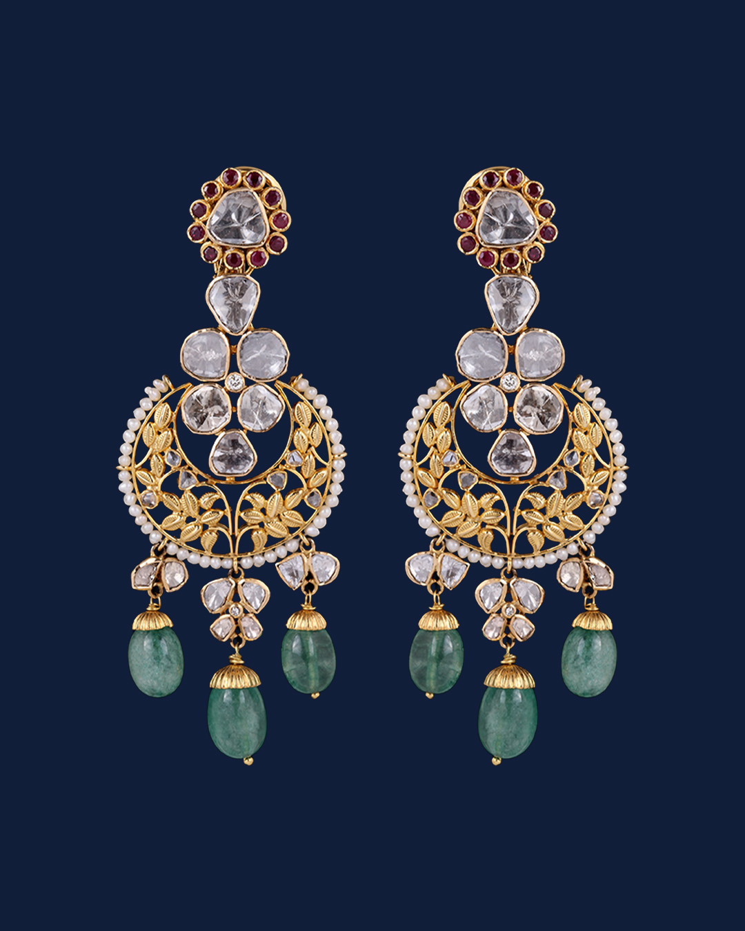 Gold diamond chandbali earrings with floral motifs and green bead drops.