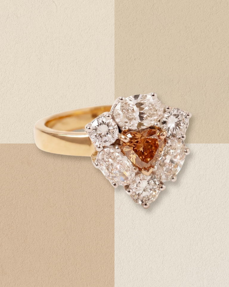 Gold ring with a brown diamond and halo setting.