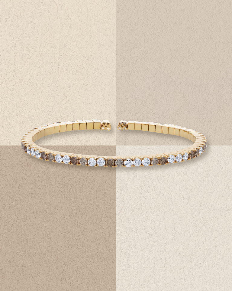 Gold bracelet set with a row of small white diamonds.