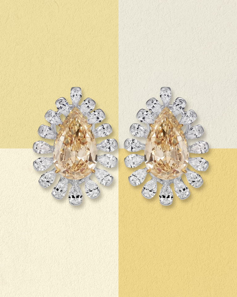Teardrop yellow diamond earrings with white diamond halo.