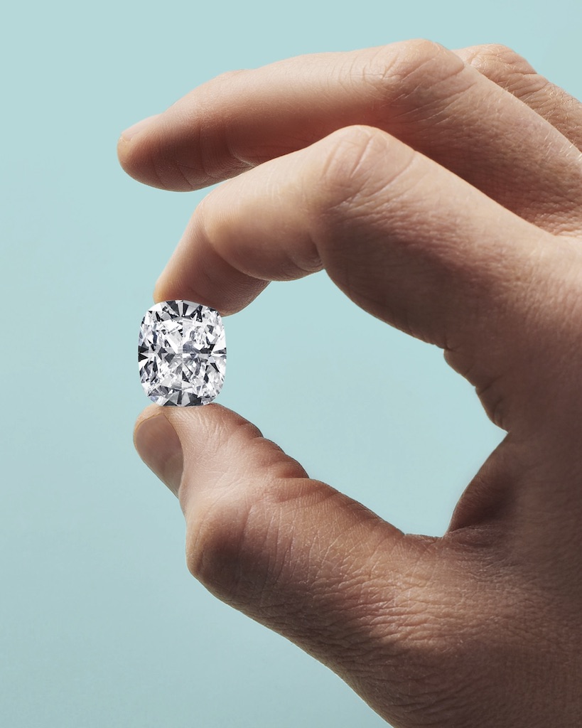 Handcrafting the Jasmine Diamond necklace from Blue Book 2026: Hidden Garden. An artisan examines a D-color, internally flawless, type IIA cushion-cut diamond of 18.80 carats.
