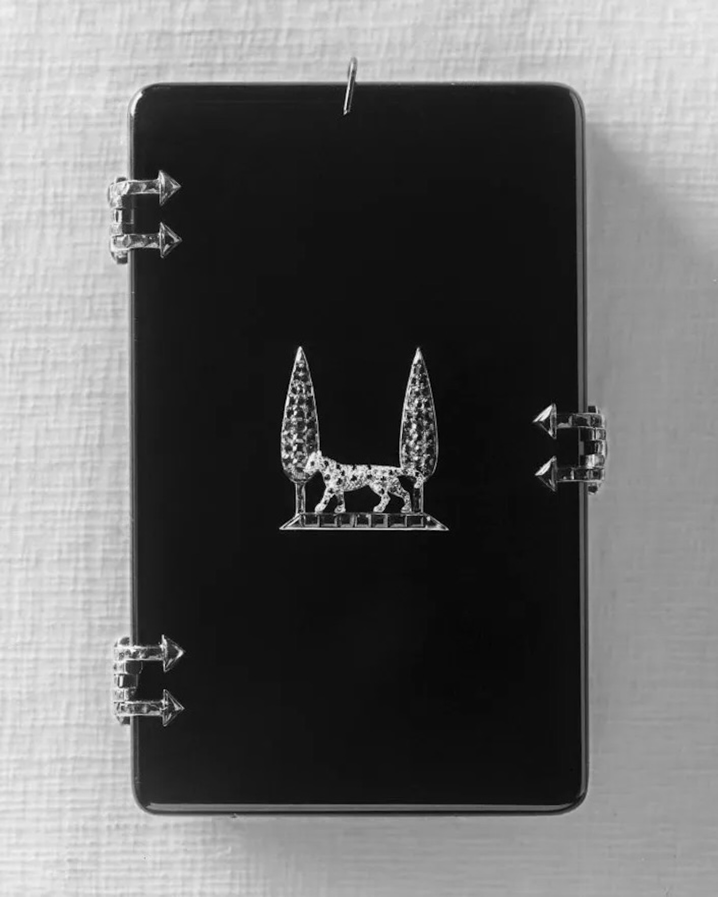 Cigarette case, Cartier Paris, 1917.  A gift from Louis Cartier to Jeanne Toussaint. Produced in onyx, rubies, and emeralds with a panther appliqué in platinum, natural diamonds, and onyx, between two cypress trees in emeralds and rubies.